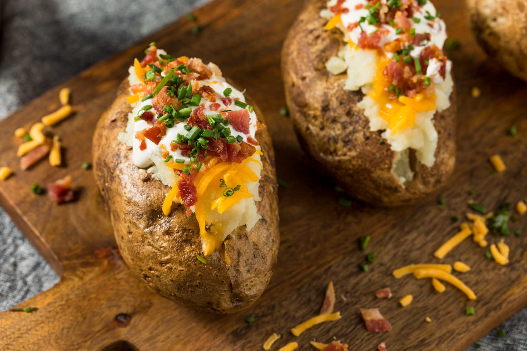 Food inspiration: baked potatoes topped with bacon, cheddar, sour cream and chives